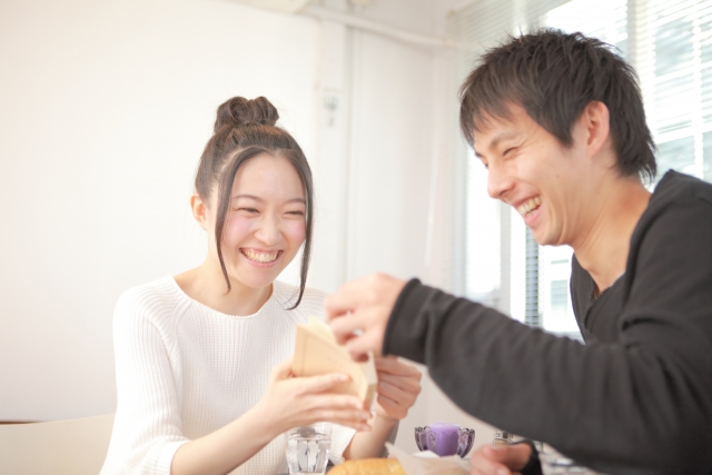 カフェで笑い合う男女の画像