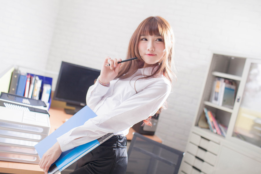 嬉しそうに考え事をしているオフィスレディ