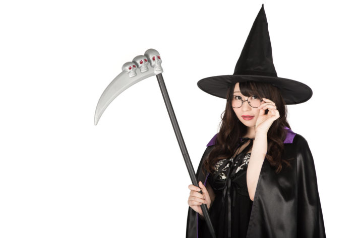 鎌を持っているコスプレしたオタク女性