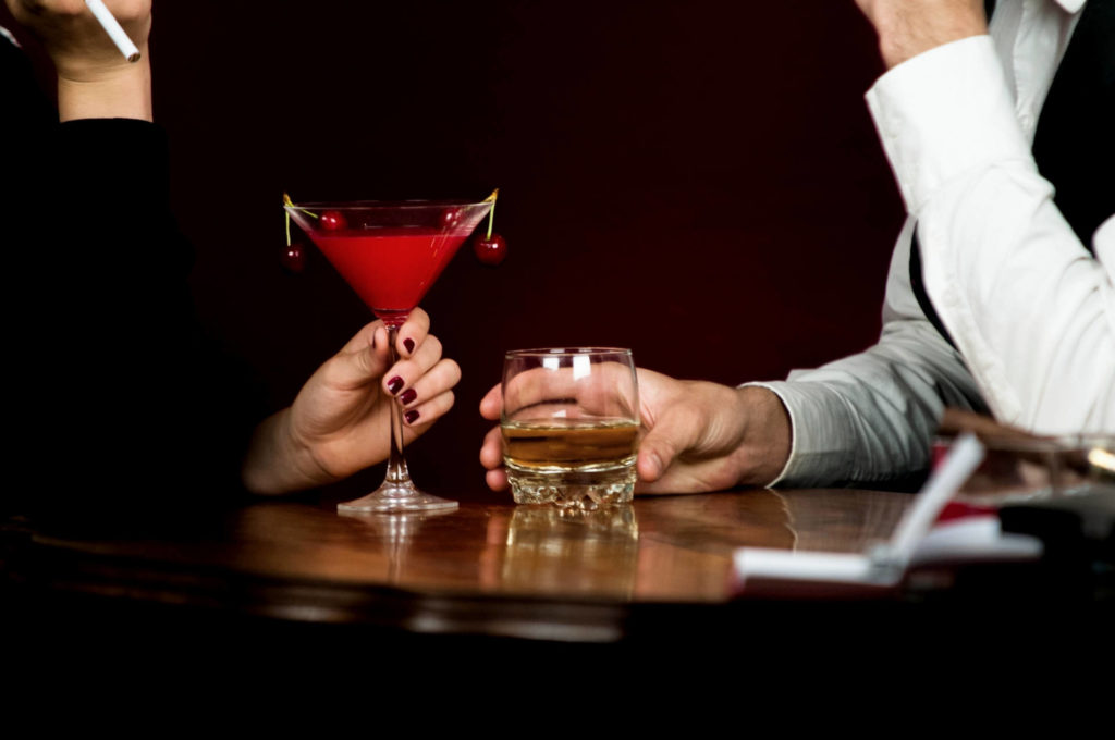 40代男女がカクテルを飲んでいる画像