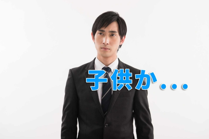 しかめっ面のスーツ姿のビジネスマンと「子供か...」の文字