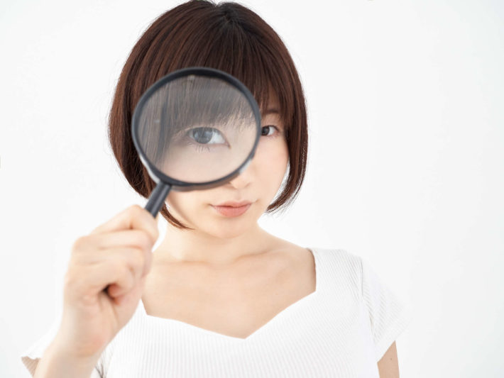 虫眼鏡を覗く女性